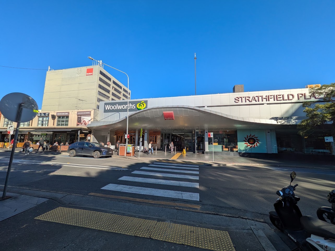 Shoppers and storefronts at Strathfield Plaza.